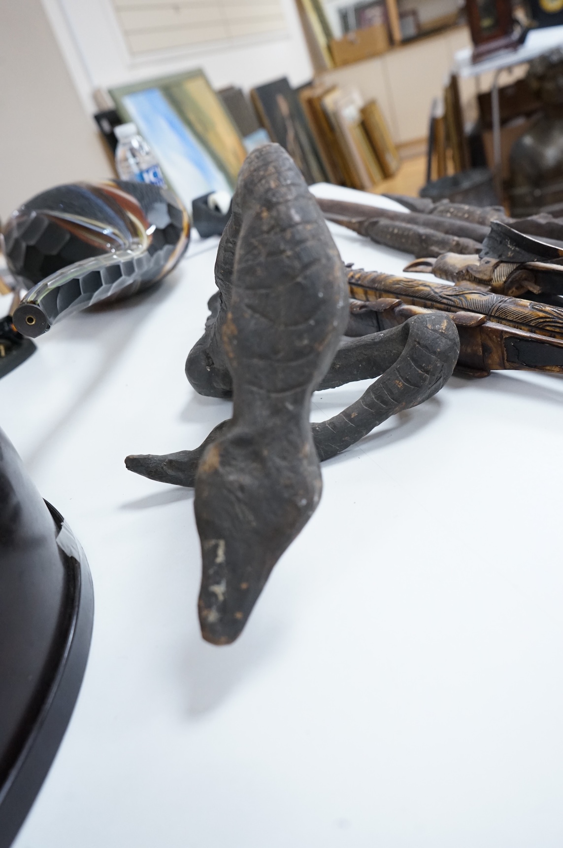 Two Papua New Guinea Sepik River carvings and a carved bone artefact, largest 92cm in length
